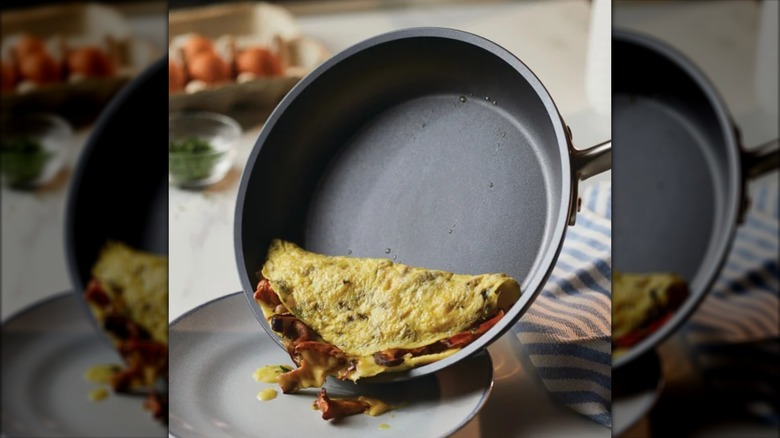 Omelet being transferred from an Anolon Accolade pan to a plate