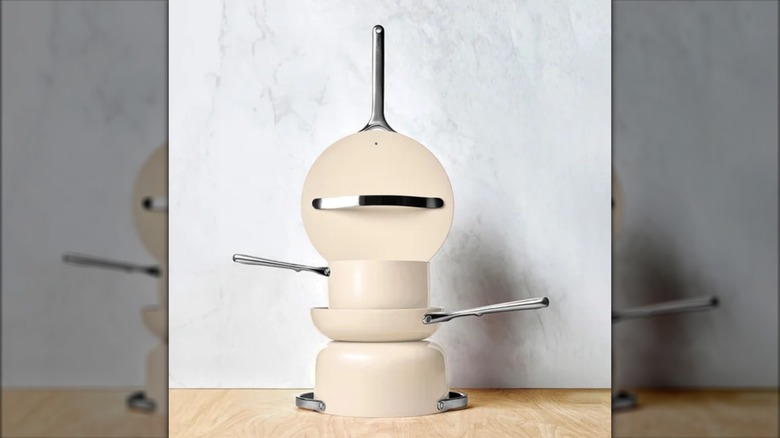 Caraway set of pots and pans stacked up on a wooden table