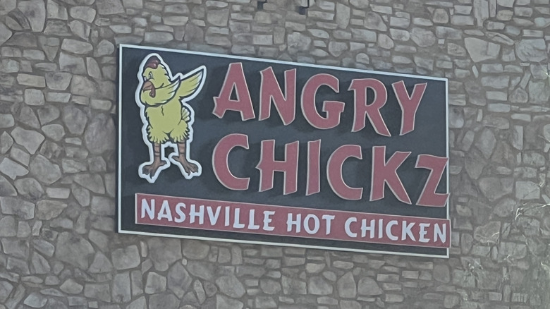 Angry Chickz Nashville Hot Chicken sign on stone building