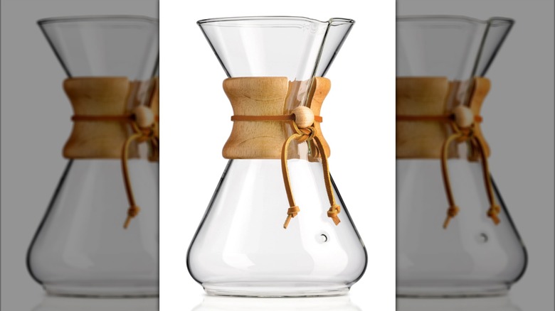 A Chemex glass pour-over brewer isolated on a white background