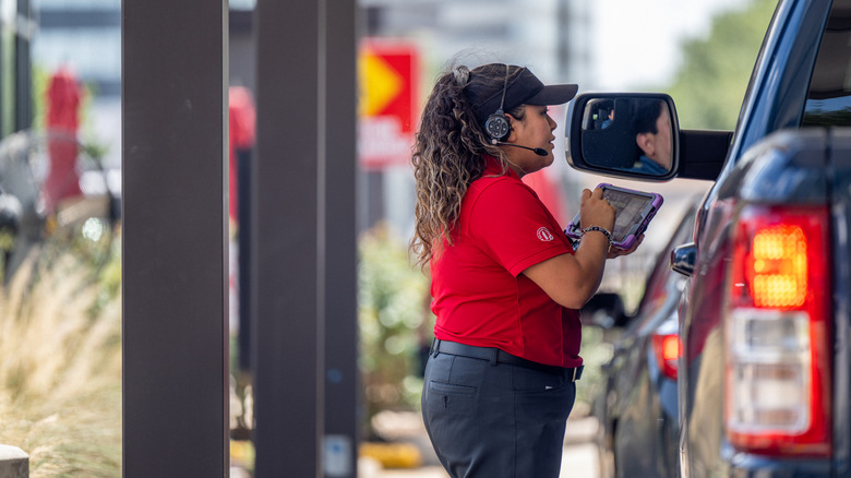 Chick-fil-A employee at window of car outside