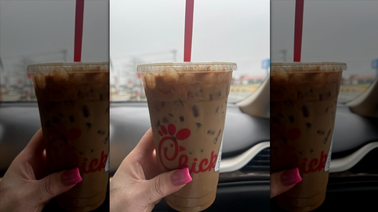 Hand holding cup of iced coffee from Chick-fil-A