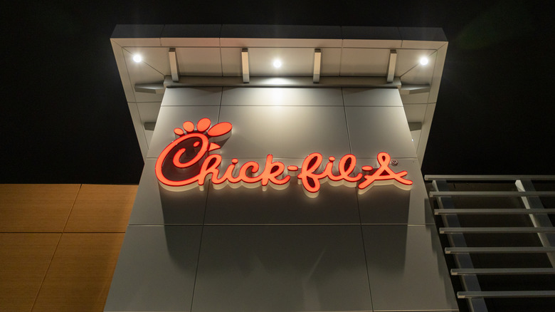 Red Chick-fil-A sign on building at night