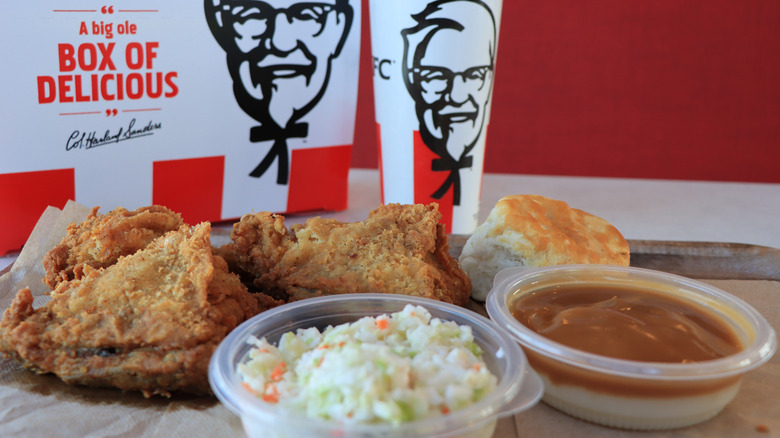 Big Box Meal with chicken, coleslaw, and gravy, and biscuit in front of KFC takeout box
