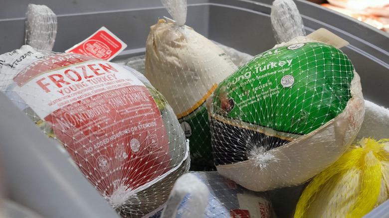 Frozen turkeys in a display freezer at a grocery store