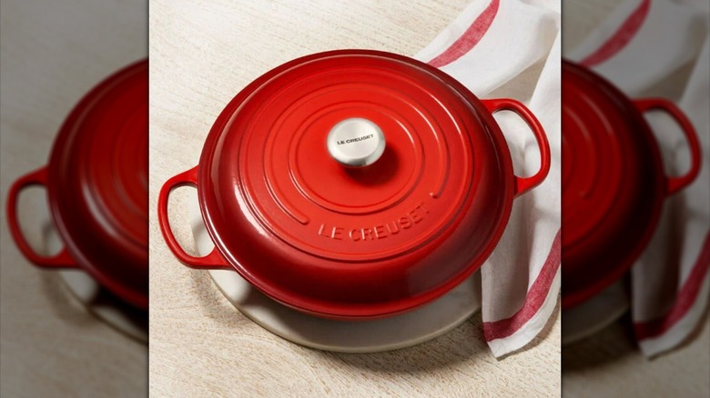 Red Le Creuset braiser with lid on