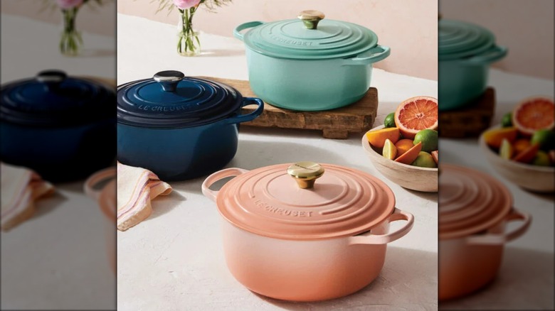 Three Le Creuset dutch ovens on kitchen countertop