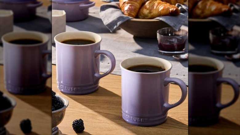 Two purple Le Creuset mugs filled with black coffee