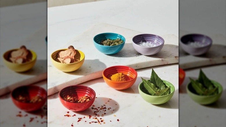 Multicolored Le Creuset pinch bowls filled with various ingredients
