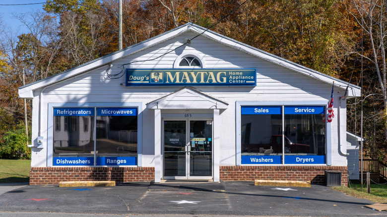 A Maytag home appliance center with the range of apliances it sells written in the windows