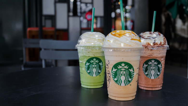 Starbuck Caramel Coffee Frappuccino ,Green Tea Cream Frappuccino and Chocolate Cream Frappuccino with blurred background at Starbucks Coffee shop.