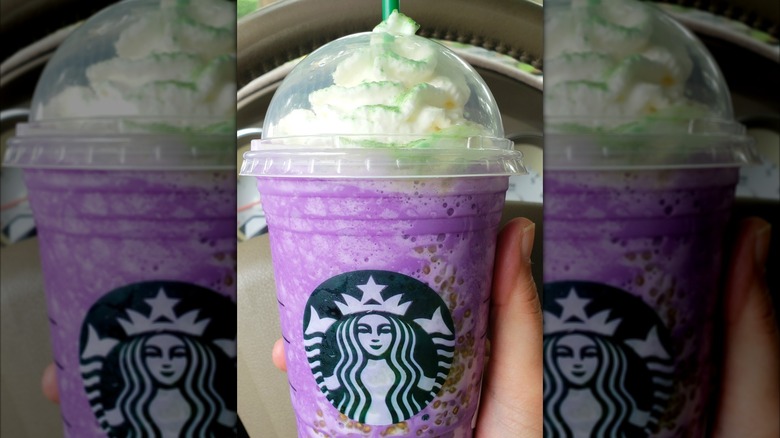 Plastic cup of Starbucks Witch's Brew Frappuccino with purple and green swirls