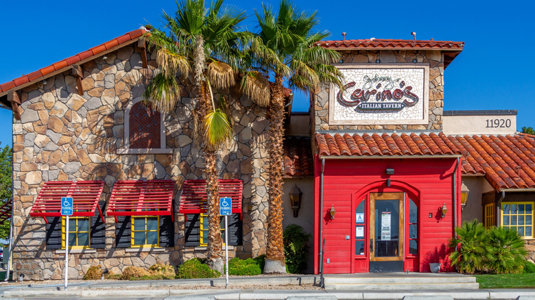 Front of Johnny Carinos Italian restuarant with palm trees.
