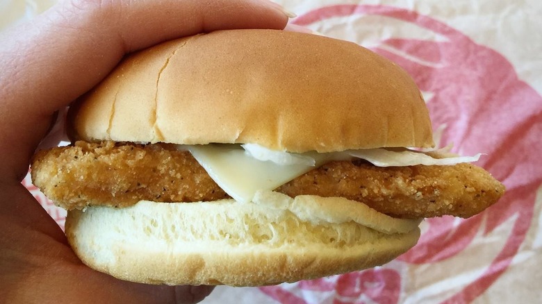 A hand holding a Wendy's Monterey Ranch Chicken Sandwich