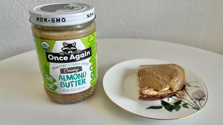 Jar of Once Again's Unsweetened and Lightly Toasted Creamy Almond Butter next to toast