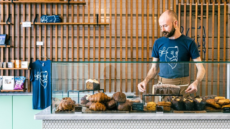 Person standing behind Scandinavian-style bakery counter