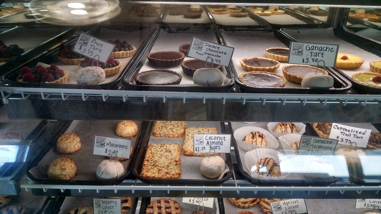 Various baked goods in glass-fronted bakery display
