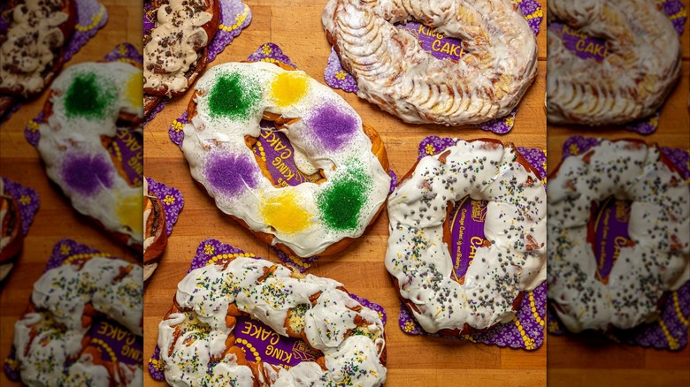 Top down view of colorful Mardi Gras king cakes on wooden table
