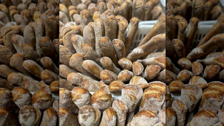 Freshly baked crusty baguettes in bakery