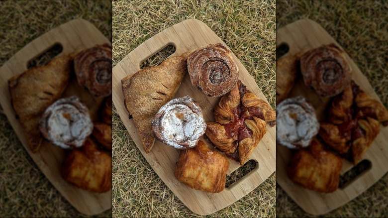 Top down view of various pastries on wooden board