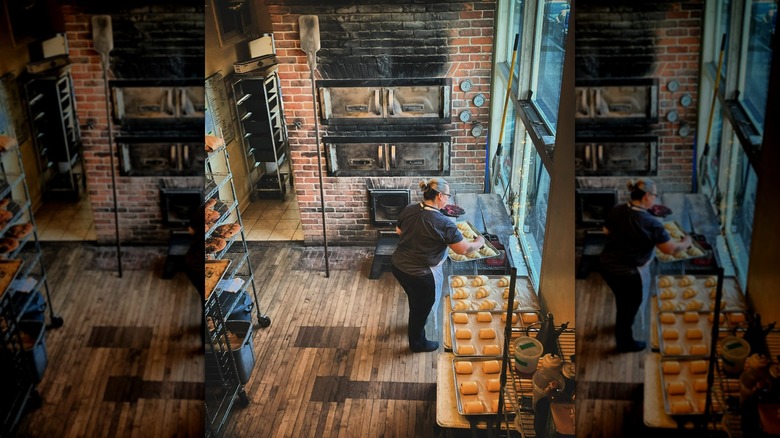 Person preparing pastries in traditional bakery kitchen