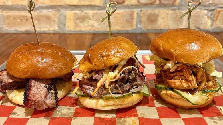 Three different types of BBQ sandwiches on red and white paper at Offset BBQ, Chicago