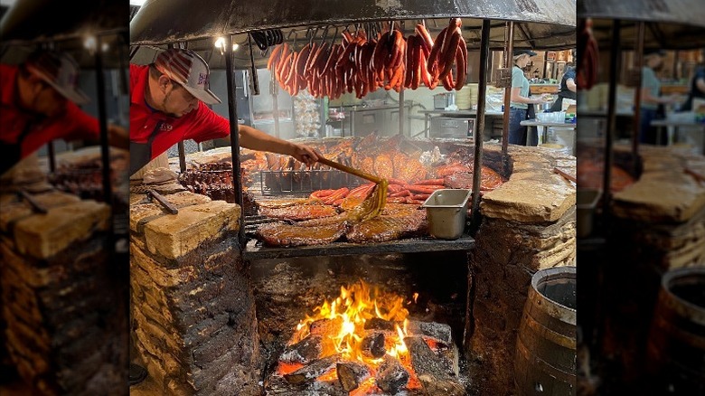 pitmaster tending to barbecue meat
