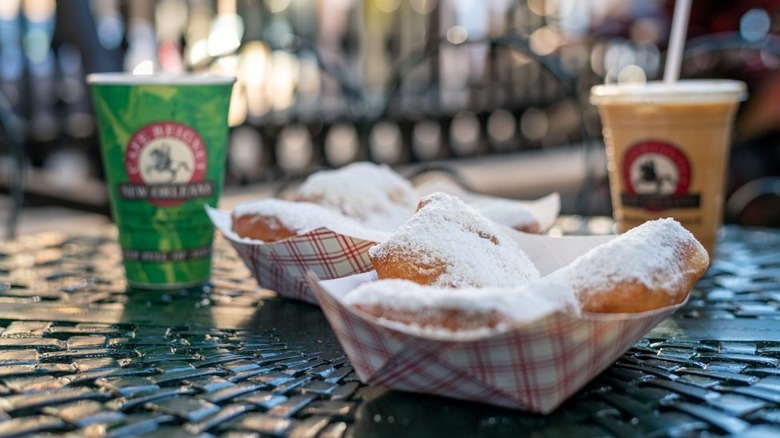 Paper baskets of beignets on table