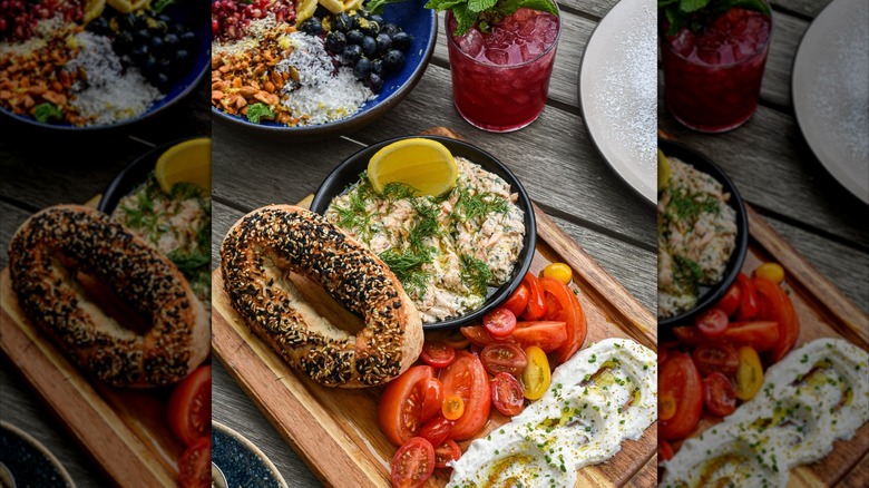 Brunch dishes including bagel, dips, bowl, and a cocktail