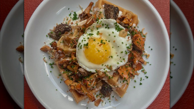 Brunch dish with eggs, waffles, and mushrooms