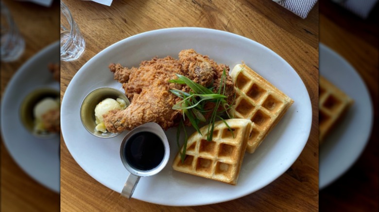 Plate with game hen, waffles, butter, and syrup