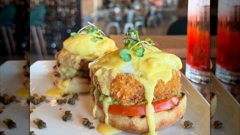 Eggs Benedict with crab cakes on table