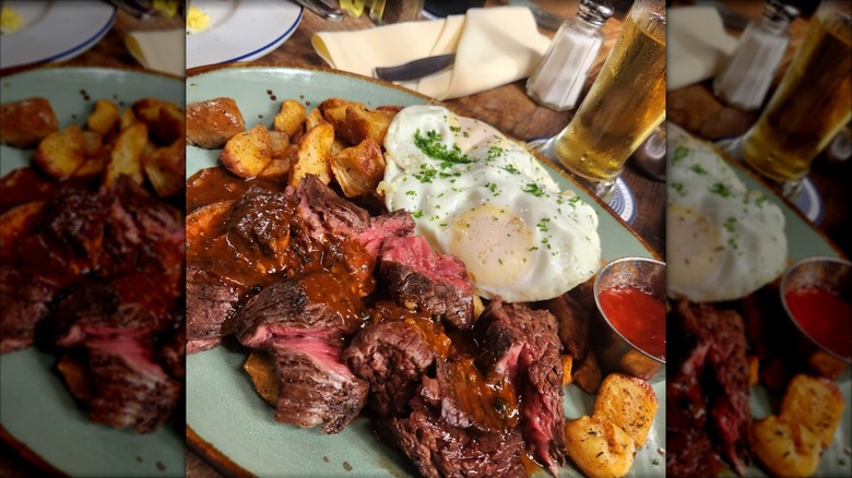 Brunch plate of steak and eggs with a beer