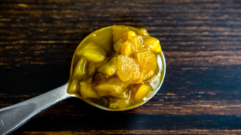 Spoonful of green chiles wood brown