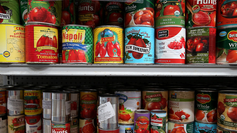 Cans of tomatoes in shelf