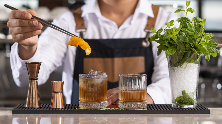Bartender serving whiskey cocktails