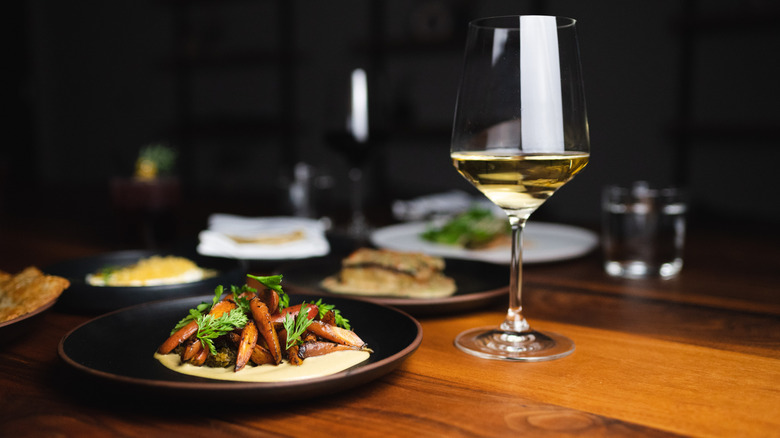 Carrots served on a puree with a glass of white wine on the side at BATA restaurant in Tuscon