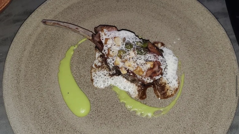 Lamb chop dish served on a gray plate at Frasca Food and Wine in Colorado
