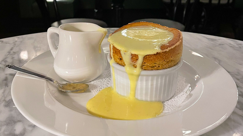 Soufflé served at The Avery in Boise with sauce served on the side and on top of the dish oozing out on the plate
