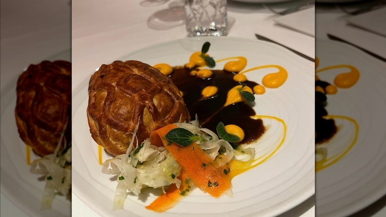 Carrot Wellington served with vegetables and sauces at Oak Park