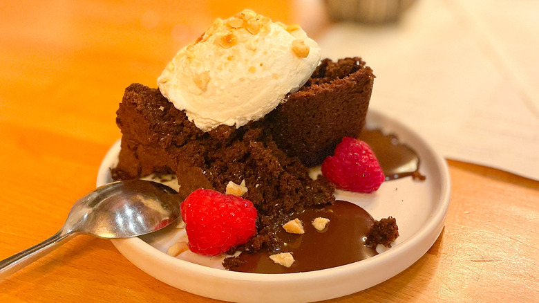 Chocolate cake with buttermilk fluff and raspberries topped with nuts served at Freight House restaurant