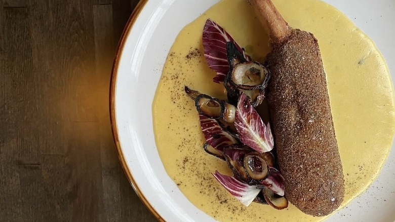 Beef rib scrumpet with aged cheddar cheese sauce, sunchokes, and grilled onions