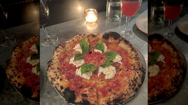 Wood-fired pizza with basil, tomatoes, and sesame at Blackbird Kitchen
