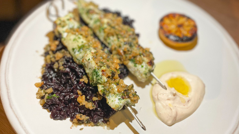 Swordfish brochettes with walnut pesto, citrus labneh, and black rice at Bastia restaurant in Philadelphia
