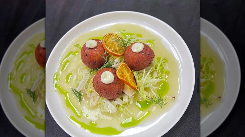 Crab zeppole with apple, celery, dill, orange lime, and frisée at Circa 1886 in Charleston