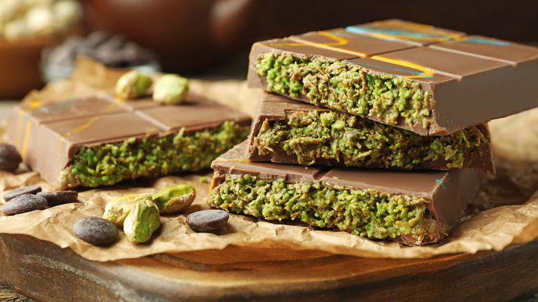 Pieces of a Dubai chocolate bar broken open on a cutting board