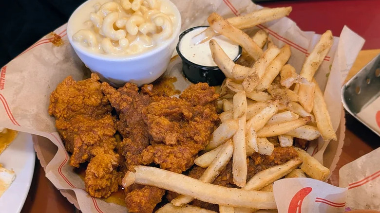 A basket of Nashville Hot Chicken Crispers at Chili's with a side of mac and cheese, fries, and ranch
