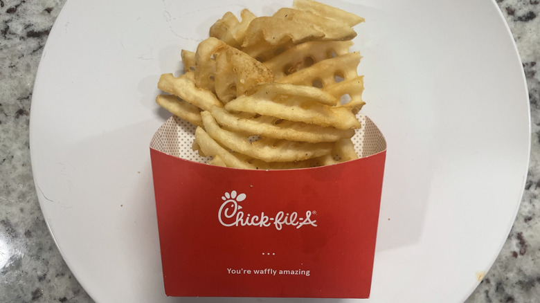 Chickfila Waffle fries in a container and on a plate