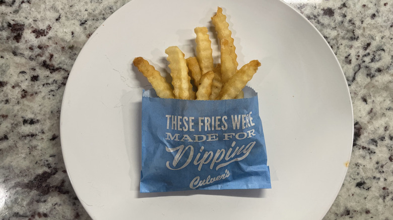 Culver's crinkle fries on a plate and in a container