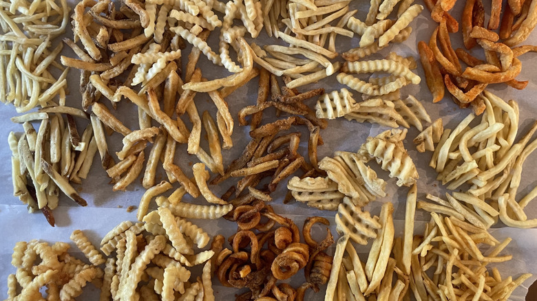 Assorted fries laid out on parchment paper